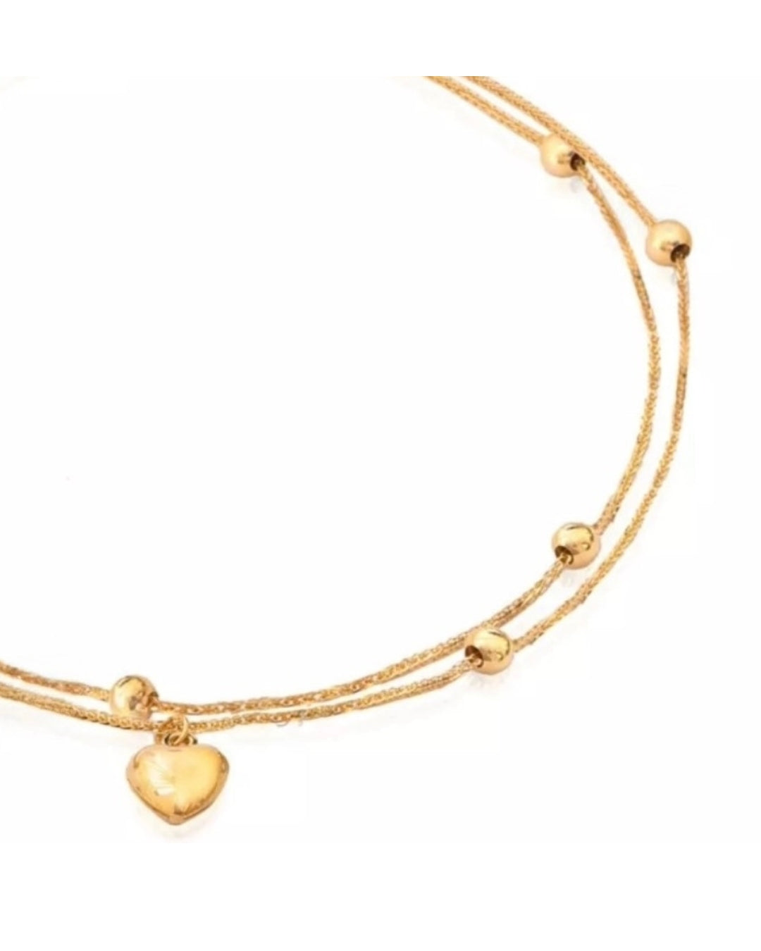 Detailansicht des Delak-Armbands aus 18k Gold mit feinem Herz und Kugelakzenten