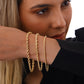 Drei goldene Kordelarmbänder Tanab-e Tala aus 18k Gelbgold – getragen am Unterarm, gedrehtes Design in verschiedenen Stärken